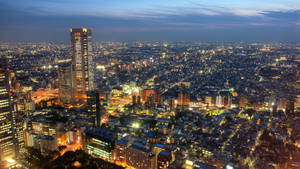 Illuminated Skyline Of Tokyo At Night Wallpaper