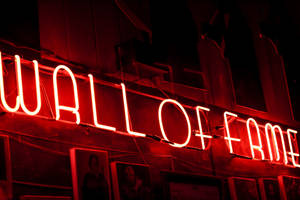 Illuminated Vibrancy: Red Aesthetic Neon Wall Of Fame Wallpaper