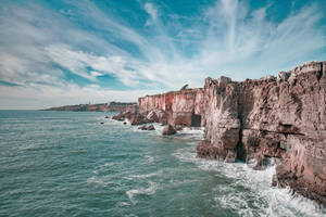 Image A Beautiful View Of The Ocean From A Beach In Portugal Wallpaper