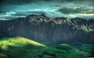 Image A Magnificent Aerial View Of Snow-covered New Zealand Mountains Wallpaper