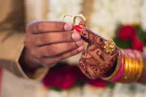 Indian Couple Enthralling Moment Of Exchanging Wedding Rings Wallpaper