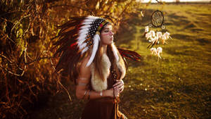 Indigenous Woman In Cultural Feathered Costume Wallpaper