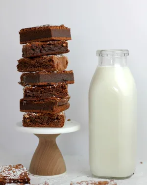 Indulgent Homemade Brownies Accompanied By Fresh Milk Wallpaper