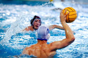 Intense Competition In Water Polo Match Wallpaper