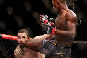 Israel Adesanya Knee On Robert Whittaker Face Wallpaper