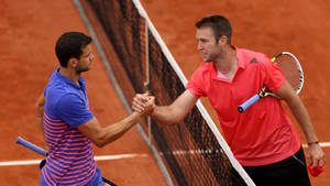 Jack Sock Displaying Amazing Sportsmanship On The Tennis Court Wallpaper