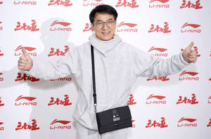 Jackie Chan Wearing A White Hoodie Wallpaper