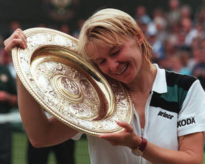 Jana Novotna Holding Trophy With Joy Wallpaper