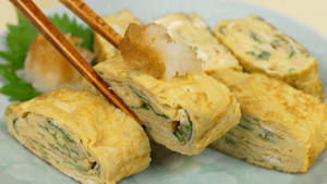 Japanese Egg Roll With Chopsticks Wallpaper