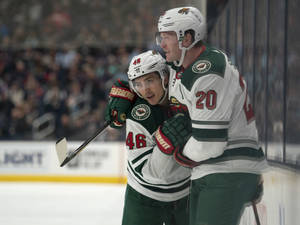 Jared Spurgeon Teammate Hug Bokeh Shot Wallpaper