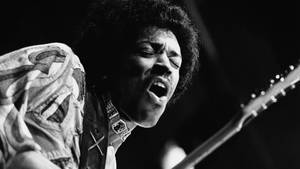 Jimi Hendrix: A Passionate Performance Wallpaper
