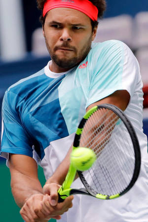 Jo-wilfried Tsonga Executing A Steady Tennis Stroke. Wallpaper