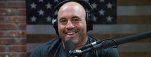 Joe Rogan Smiling On Show Wallpaper