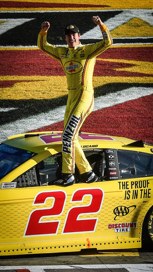 Joey Logano Standing On Car Window Wallpaper