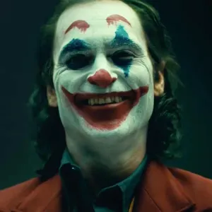 Joker Laughing Maniacally In The Dark Wallpaper