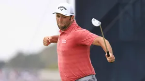 Jon Rahm Jumping For Victory Wallpaper
