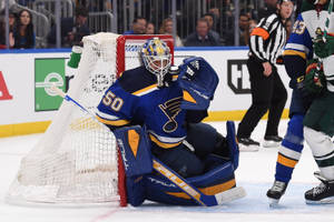 Jordan Binnington In Action, Showing His Defensive Skills In The Hockey League Wallpaper