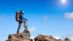 Journey Of Man Standing On Rock Wallpaper