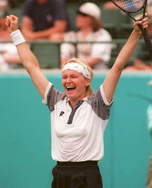 Jubilant Jana Novotna Raising Her Hands Triumphantly Wallpaper