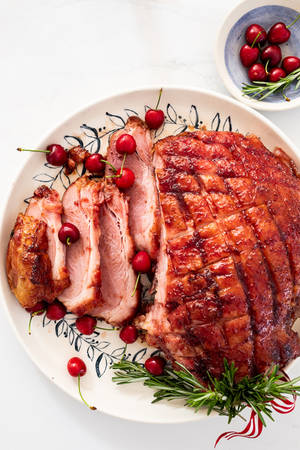 Juicy Ham Adorned With Sweet Cherries Wallpaper