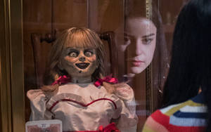 Katie Sarife And Annabelle Doll Wallpaper