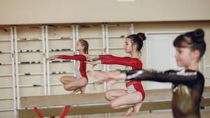 Kids Gymnastics Class Balance Beam Wallpaper