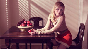 Kirsten Dunst Holding Apple Wallpaper