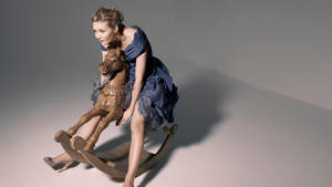 Kirsten Dunst On Rocking Horse Wallpaper