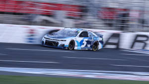 Kyle Larson In Thrilling Racing Action Wallpaper