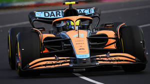 Lando Norris’ Orange Race Car Wallpaper