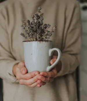 Lavender Flowers In Mug On Hands Wallpaper
