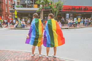 Lesbian Gay Couple Wearing Flags Wallpaper