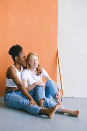 Lesbian Girl Sitting On Floor Wallpaper