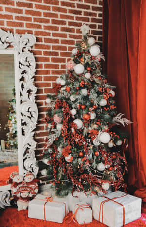 Let Christmas Feelings Envelop Your Home With This Beautiful Aesthetic Christmas Tree Wallpaper