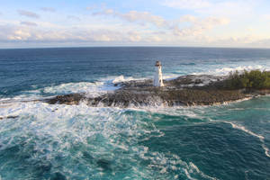 Lighthouse And Waves In Bahamas Wallpaper