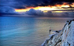 Lighthouse Below Cliffs Wallpaper