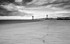 Lighthouse Footsteps In Sand Wallpaper