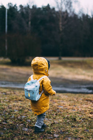 Little Boy In Yellow Raincoat Wallpaper