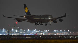 Lufthansa Plane In Action At Night Wallpaper