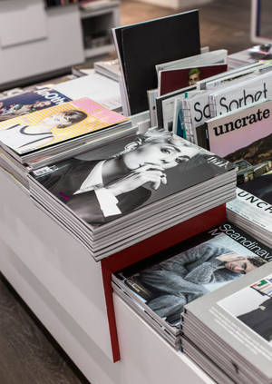 Magazines Stacked On A Table Wallpaper