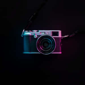 Magnificent Photography Camera Illuminated By Enchanting Purple Light Wallpaper