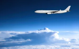 Magnificent White Airplane Soaring Through The Sky Wallpaper
