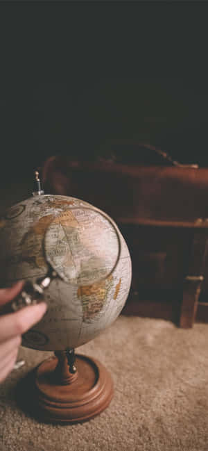 Magnifying Glass On A Mini Globe Wallpaper