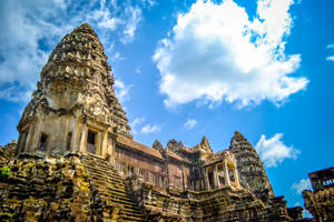 Majestic Angkor Wat Under A Brilliant Blue Sky Wallpaper