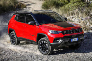 Majestic Black And Red Jeep Compass Dominating The Gravel Road Wallpaper