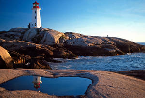 Majestic Peggy's Point Lighthouse Illuminating Canada's Coastal Beauty Wallpaper