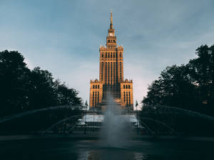 Majestic Poland's Palace Of Culture Against Blue Sky Wallpaper