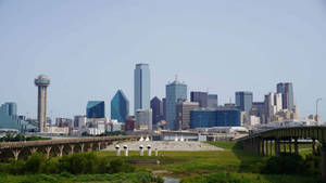 Majestic View Of Dallas Skyline At Dusk Wallpaper