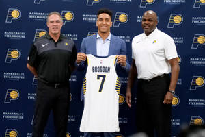 Malcolm Brogdon Holding His Jersey Wallpaper