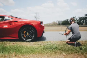 Man Behind Red Ferrari Wallpaper
